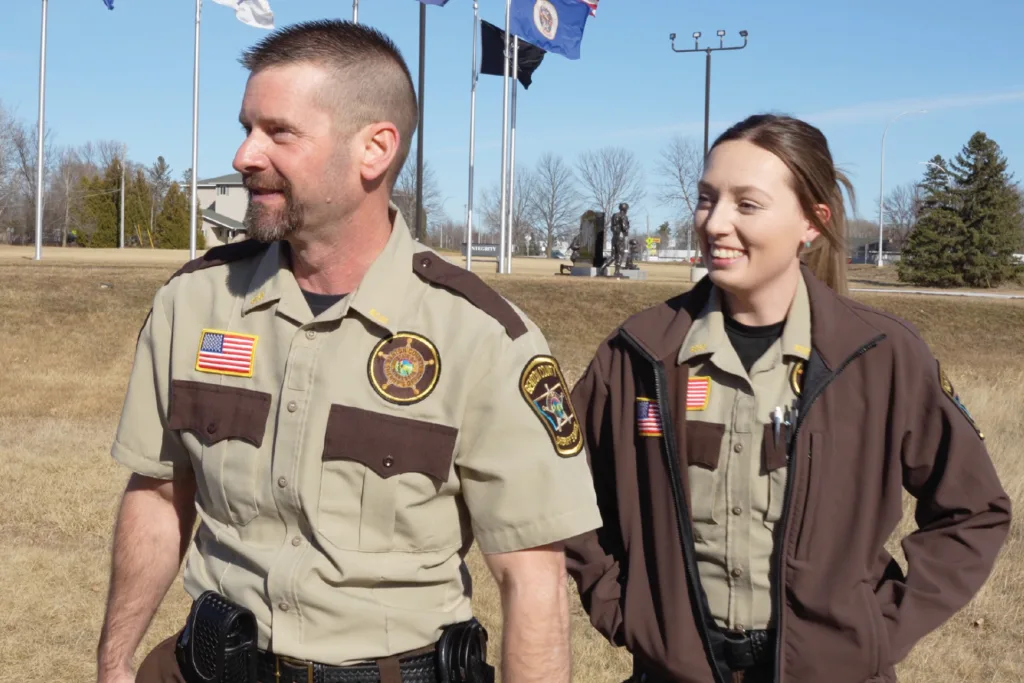 Two detention officers outside smiling
